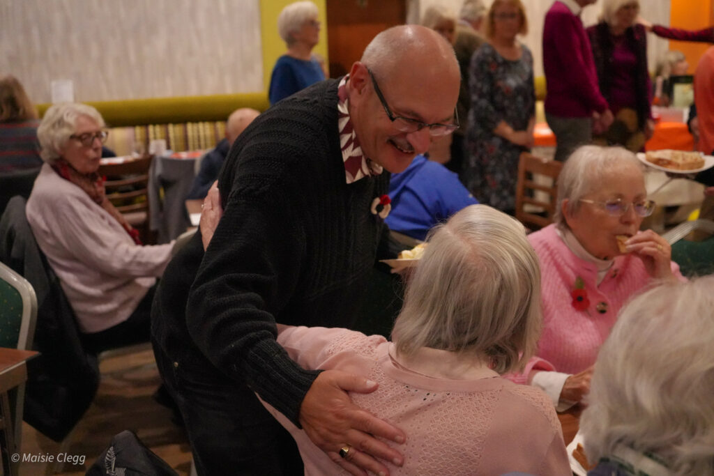 Two people talking at a charity social event.