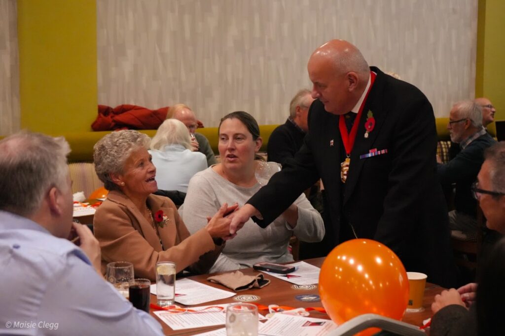 Two charity members shaking hands.