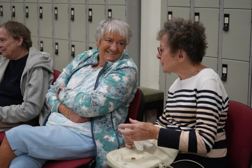 Two women talking at bowls social event.